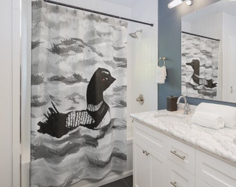May include: A black and white shower curtain with a watercolor-style illustration of a loon swimming in the water.
