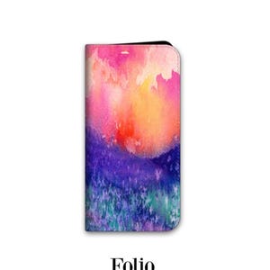 A colorful, abstract watercolor painting of a landscape with vibrant hues of pink, orange, purple, and blue.