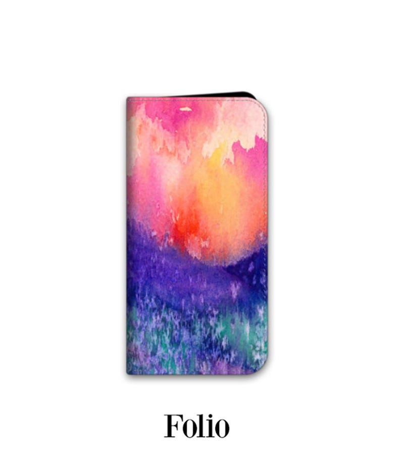 A colorful, abstract watercolor painting of a landscape with vibrant hues of pink, orange, purple, and blue.