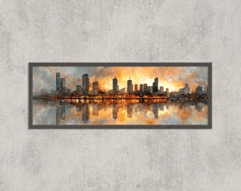 May include: A framed panoramic cityscape painting. The artwork depicts a skyline with tall buildings silhouetted against a vibrant orange and yellow sunset. The buildings are reflected in the water below, creating a symmetrical composition.