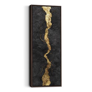 May include: Abstract wall art featuring a dark textured background with a vertical gold metallic design. The artwork is framed in a dark brown wooden frame, creating a modern and elegant aesthetic. The gold design resembles a crack or vein.