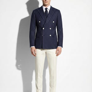 May include: A set of three ceramic mugs with a speckled, matte finish. The mugs are in shades of cream, light gray, and dark gray. Each mug has a simple, minimalist design and a rounded handle.