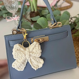 Ivory crochet bow bag charm keychain – handmade purse accessory, cute and trendy yarn bow keyring for handbags, backpacks, or gifts