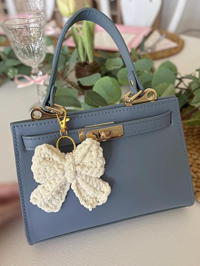 Ivory crochet bow bag charm keychain – handmade purse accessory, cute and trendy yarn bow keyring for handbags, backpacks, or gifts