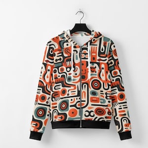 Puede incluir: Una sudadera con cremallera con un patrón abstracto vibrante en naranja, negro, verde azulado y crema. El diseño presenta formas y líneas geométricas. La sudadera tiene dobladillo y puños negros e interior blanco.