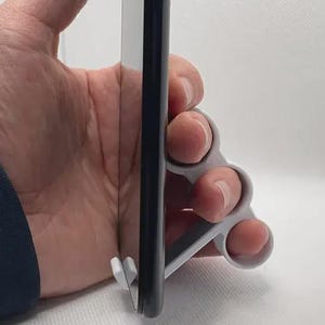 May include: A set of three ceramic mugs with a speckled, matte finish. Each mug features a different color: light blue, cream, and gray. The mugs have a simple, modern design and a comfortable handle.