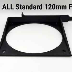 May include: A black square fan mount with a circular opening, designed to fit 120mm fans. The text "Fits ALL Standard 120mm Fans" is printed above the mount. The mount has screw holes for installation.