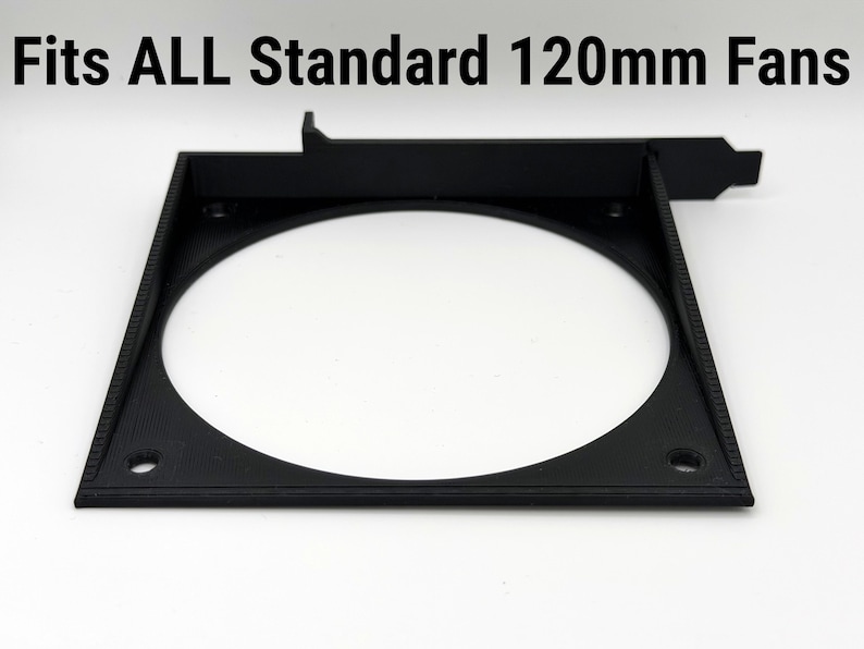 May include: A black square fan mount with a circular opening, designed to fit 120mm fans. The text "Fits ALL Standard 120mm Fans" is printed above the mount. The mount has screw holes for installation.