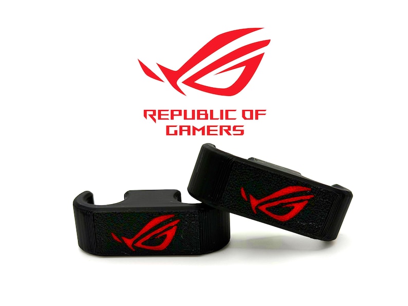 May include: Two black gaming accessories with a red logo, featuring the text "REPUBLIC OF GAMERS" above. The logo is a stylized red design. The accessories are on a white background.