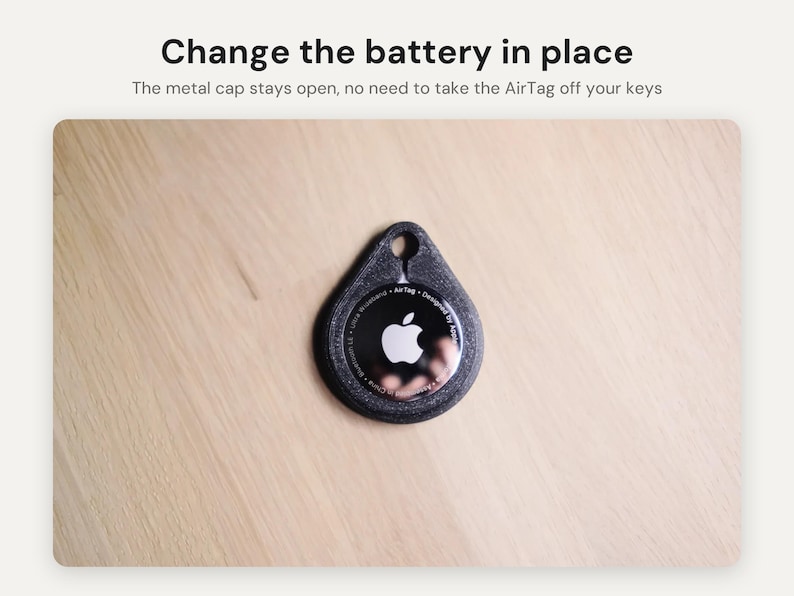 May include: A black textured protective holder for an Apple AirTag with a teardrop shape and a circular cutout at the top. The text Change the battery in place and The metal cap stays open, no need to take the AirTag off your keys is visible.