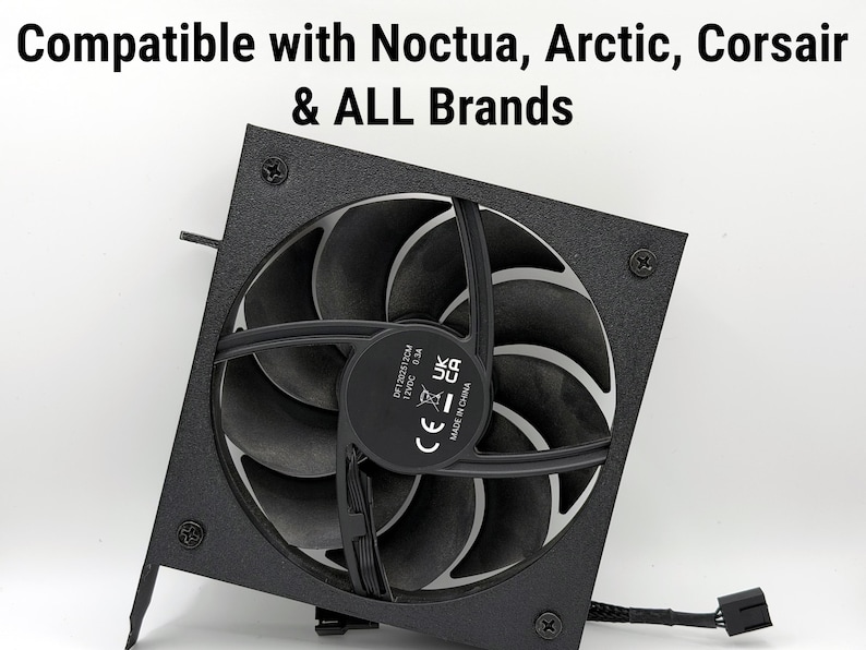 May include: A black computer fan with curved blades and a central hub. The fan is mounted on a square frame and has a power connector. Text at the top reads "Compatible with Noctua, Arctic, Corsair & ALL Brands".