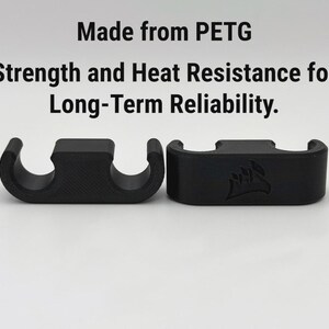 May include: Two black, curved plastic cable organisers. The text above reads "Made from PETG. Strength and Heat Resistance for Long-Term Reliability.". One organiser has a logo.