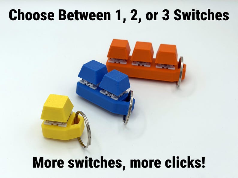 May include: Three keycap-shaped keychains in yellow, blue, and orange. Each keychain has a different number of keycaps: one, two, and three. The text reads: "Choose Between 1, 2, or 3 Switches" and "More switches, more clicks!"