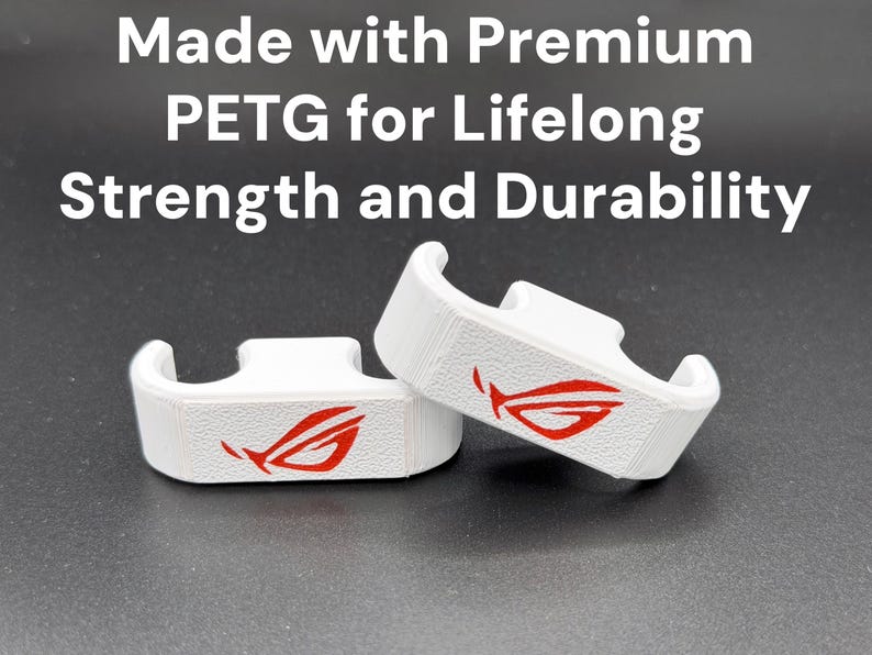 May include: Two white 3D-printed brackets with a red logo, on a dark surface. The brackets have a curved design with a slot on top. Text above reads "Made with Premium PETG for Lifelong Strength and Durability."