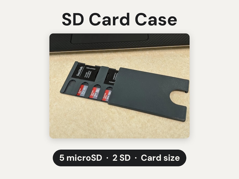 May include: A dark gray SD card case with a sliding cover, designed to hold 5 microSD cards and 2 SD cards. The case features the text SD Card Case at the top and 5 microSD &middot; 2 SD &middot; Card size at the bottom, with visible SanDisk memory cards.