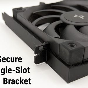 May include: A black single-slot PCI bracket with a fan. The fan has curved blades and a central hub. The text "Secure Single-Slot PCI Bracket" is visible in the image.