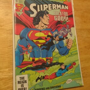May include: A Superman comic book titled "Reign of the Supermen!" features Superman in a blue suit with a red cape. The cover art includes multiple figures in flight, with the text "Back for Good!" and "The Reign is Over!"