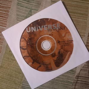 May include: A CD-ROM disc with the title "UNIVERSE BEYOND" in gold lettering, inside a white paper sleeve. The disc has a brown and orange design. The text "Windows CD-ROM" is visible on the disc.