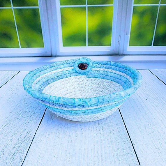 A coiled rope basket with a real Lake Superior agate tucked in — earthy, tactile, and genuinely one-of-a-kind since every agate is unique.