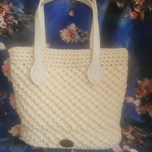 crochet handbag with &quot;leather&quot; bottom and handles . Inside the cotton lining is  in a pink colour