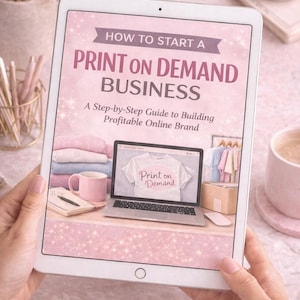 May include: A tablet showing a guide titled "How to Start a Print on Demand Business." The screen displays a laptop with a t-shirt design, a coffee cup, and folded shirts. The guide offers a step-by-step approach to building a profitable online brand.