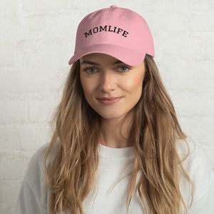 May include: A pink baseball cap with the text "MOMLIFE" embroidered in black on the front.