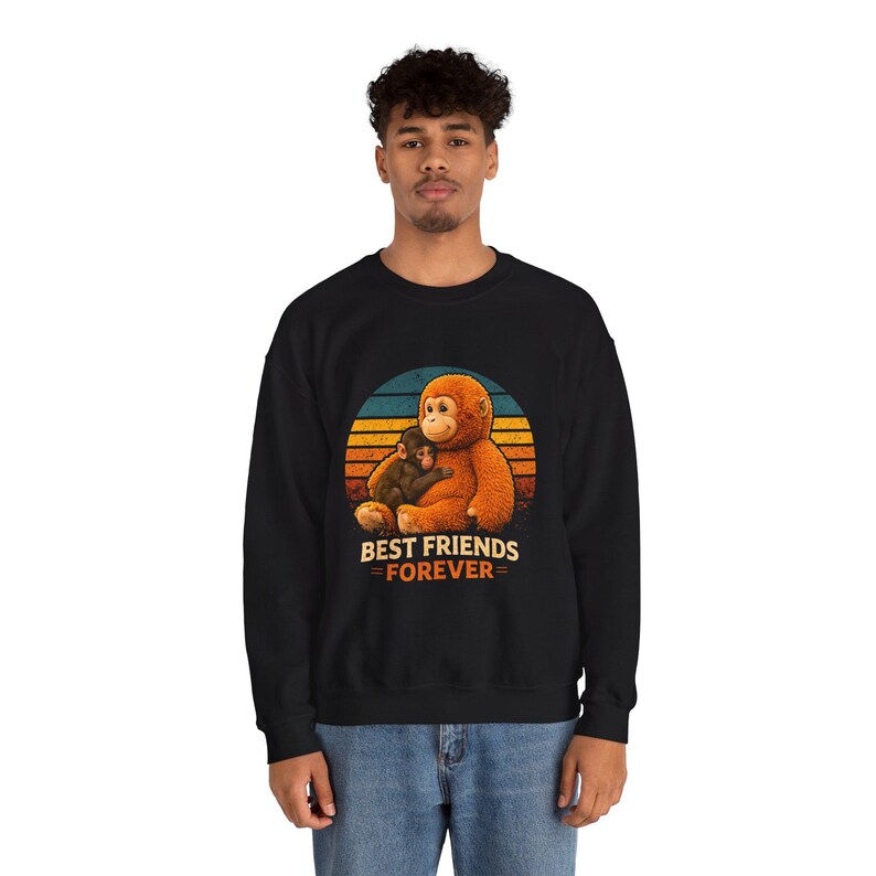 May include: Black sweatshirt featuring a graphic of two orangutans hugging, set against a sunset design. The text "BEST FRIENDS FOREVER" is below the image in orange and white.