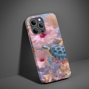 May include: A phone case featuring a vibrant underwater scene. The design includes a blue sea turtle, pink hibiscus flowers, starfish, and coral against a light blue background. A seashell is also visible. The case is designed for a smartphone.