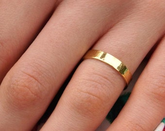 Gold Wedding Band: A 14k yellow recycled gold textured wedding ring band