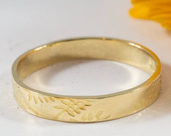 Gold Botanical Wedding Bands: A Set of hers and hers textured 14k recycled gold wedding rings