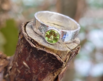 Peridot Ring: A recycled sterling silver ring with a 5mm faceted green Peridot