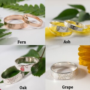 K&ouml;nnte beinhalten: Vier Paare silberner und ros&eacute;goldener Eheringe mit verschiedenen Blattdesigns. Die Ringe sind mit "Fern", "Ash", "Oak" und "Grape" beschriftet.