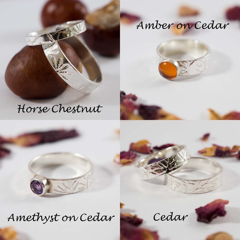 K&ouml;nnte beinhalten: Vier Silberringe mit verschiedenen Steinen und Texturen. Die Ringe werden auf einem wei&szlig;en Hintergrund mit nat&uuml;rlichen Elementen wie Rosskastanien und Rosenbl&uuml;ten pr&auml;sentiert. Die Ringe sind mit "Amber on Cedar", "Amethyst on Cedar", "Cedar" und "Horse Chestnut" beschriftet.
