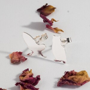 Silver Owl Earrings: A pair of owl shaped recycled sterling silver earrings.