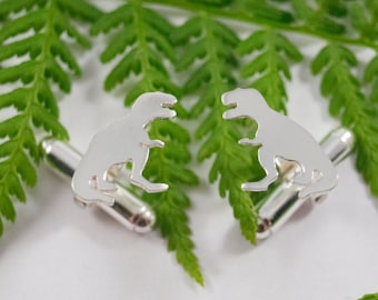 Silver Dinosaur cufflinks: A matching pair of T Rex shaped sterling silver cufflinks.
