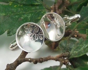 Silver Cuff links: Sterling silver cuff links with an oak leaf pattern imprinted.