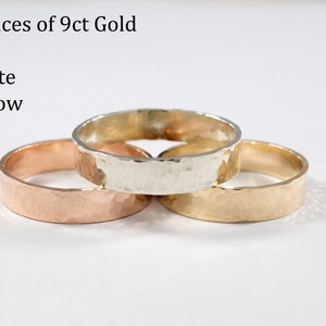 May include: Three 9ct gold rings in yellow, white, and red gold. The rings are hammered and have a textured finish.