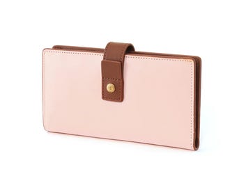 May include: A pink leather wallet with a brown leather flap and a gold button closure.