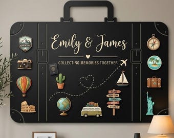Puede incluir: Un panel de pared negro con forma de maleta y asa. Incluye el texto "Emily & James" y "COLLECTING MEMORIES TOGETHER" junto a varios iconos de temática viajera, como un globo terráqueo, una furgoneta, un avión y diversos monumentos.