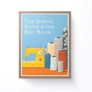 May include: A framed print with the text "The Sewing Room Is The Best Room." The image features a yellow sewing machine, spools of thread in various colors, and a blue and orange background. The spools of thread are in shades of blue, beige, gray, and red.