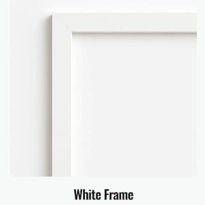May include: A close-up of a white picture frame with a clean, modern design. The frame is a bright white color and has a simple, rectangular shape. The text "White Frame" and "A clean white framing option" are at the bottom.
