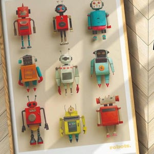 May include: A framed print featuring nine colorful, vintage-style robot illustrations. Each robot has a unique design with various shapes, colors, and details. The word "robots" is printed in a white, sans-serif font at the bottom right.