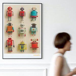 May include: A framed print featuring nine colorful robot illustrations. The robots are in various colors, including red, blue, yellow, and orange, with detailed mechanical designs. The word "robots" is printed in the lower right corner.