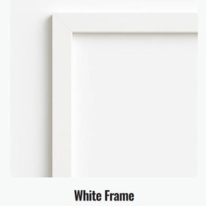 May include: A close-up of a white picture frame with a clean, modern design. The frame is a bright white color and has a simple, rectangular shape. The text "White Frame" is displayed below the frame.