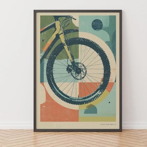 Peut inclure: Une impression d'art encadrée présentant une illustration graphique stylisée de la roue avant et du cadre d'un VTT. Le design utilise une palette de couleurs sourdes orange, bleu sarcelle et crème avec des formes géométriques et le texte CT.VV 3 MT OBY 8.