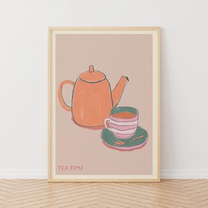 May include: A framed art print depicting a teapot and teacup. The orange teapot has a dark blue outline, and the teacup features pink and white stripes. The teacup rests on a green saucer with a gold spoon. The words "TEA TIME" are printed at the bottom.