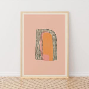May include: Framed abstract art print featuring a peach background with a central design in orange, pink, and green. The design includes a curved shape with vertical lines and a textured, organic form, creating a modern aesthetic.