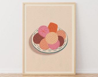 May include: A framed art print featuring a plate of colorful, stylized cookies. The cookies are various shades of pink, orange, and brown, with textured details. The plate has a blue and white rim. The background is a soft peach color.