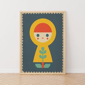 May include: A framed art print featuring a stylized illustration of a figure in a yellow hooded coat and a red hat. The figure is set against a dark blue background with a decorative border. A green plant is at the bottom.