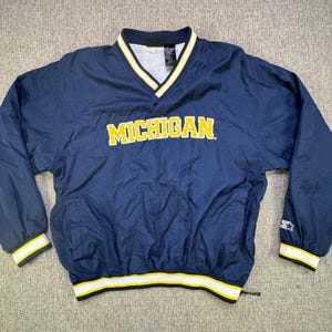 May include: A white ceramic mug with a black handle and the text "But First, Coffee" in a handwritten style. The mug is on a white surface. The mug is 4 inches tall.